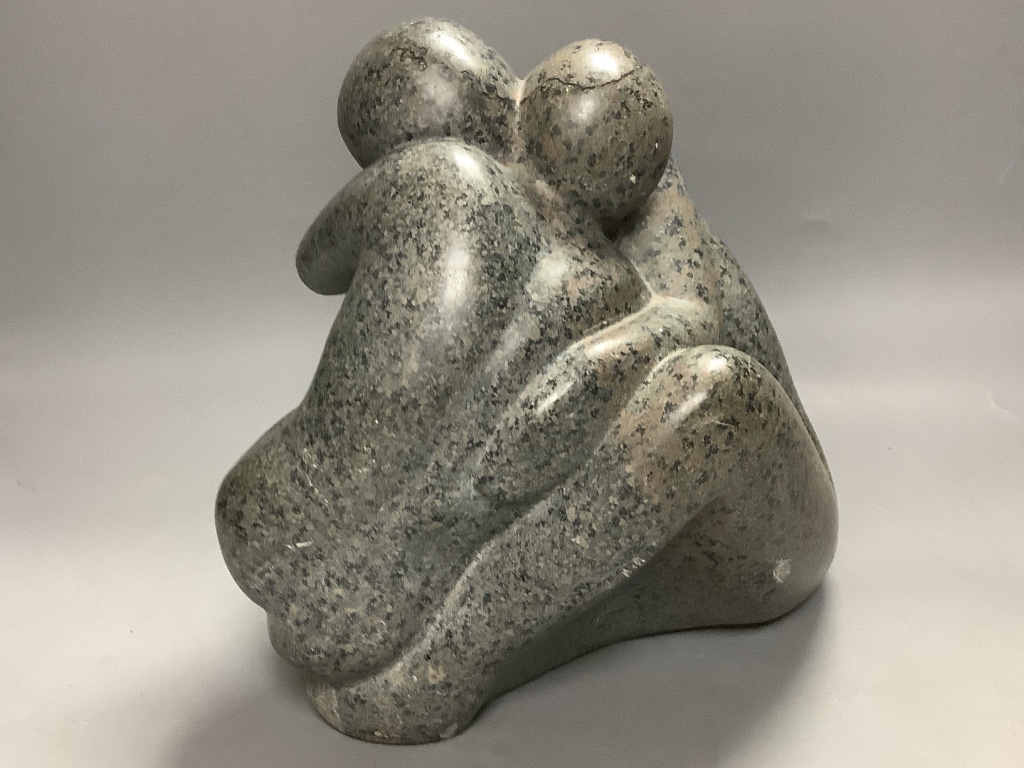 Modern British, a carved granite group of an embracing couple, initialled JMB?, height 26cm